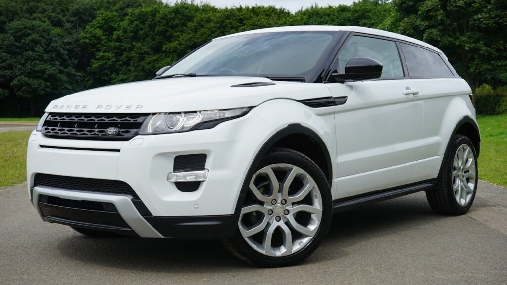 pexels-photo-116675 Stylish white Range Rover parked on a road in a green outdoor setting, showcasing its luxury design.